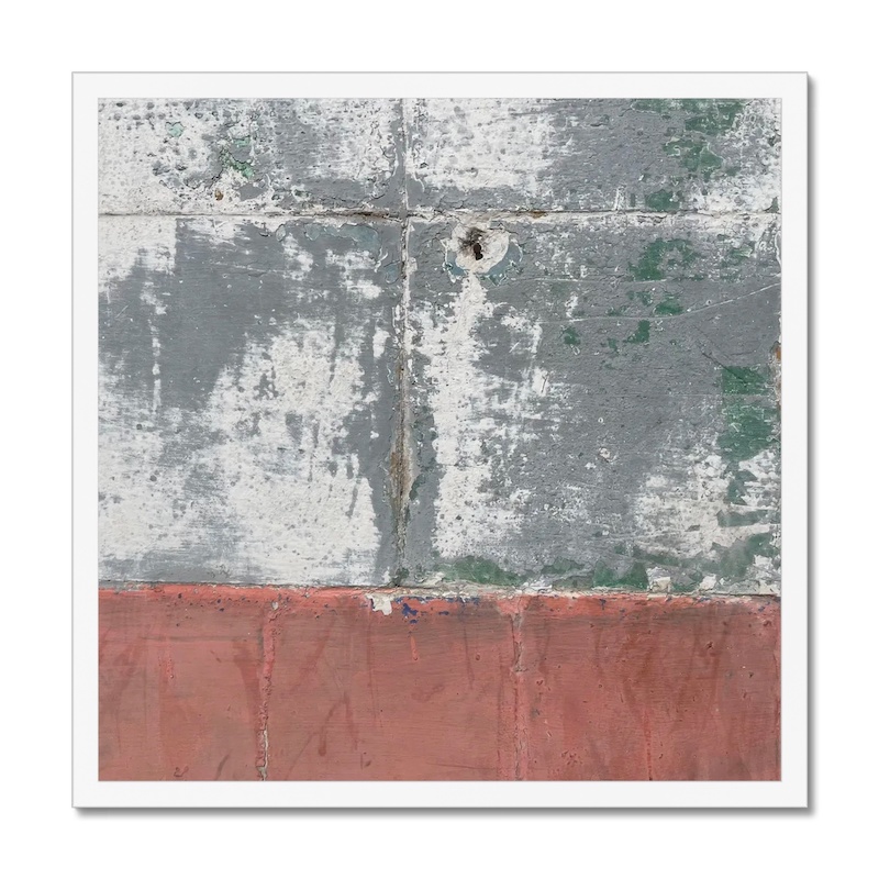 White-framed 20x20 inch photo depicting a weathered wall with traces of green and a notable bullet hole.