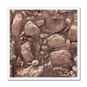 Warm and earthy sunbaked wall constructed from irregular shaped stones reminiscent of a arid dessert landscape.