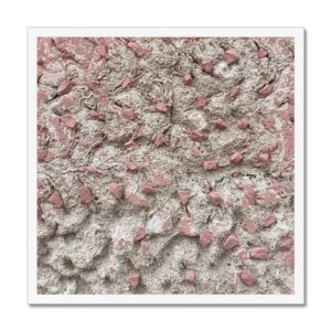 Crumbling concrete wall with pattern of small pink stone protrusions framed for 20x20” wall hanging.