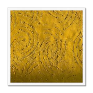 Photo of textured concrete wall with a rich golden hue mounted in white picture frame.