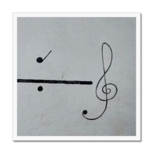 Framed 20x20” picture of a black treble clef painted on a white wall depicting flow, rhythm, and movement.