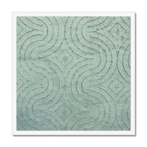 Galactic Mayan textile pattern work in the surface of a greenish-blue concrete wall framed for wall hanging.