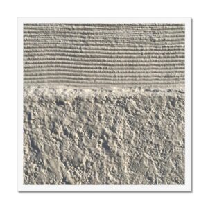 Textural contrast of heavy concrete grooves against a rough finish in white 20x20” frame.