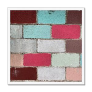 Unconventional patchwork of bright retro colors on a cinderblock wall mounted inside a 20x20" white picture frame.