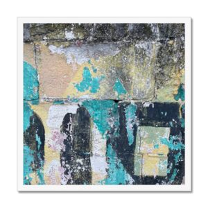 This 20x20 inch framed photo features remnants of a painted sign on a cinder block wall, with layers of weathered paint in various colors.