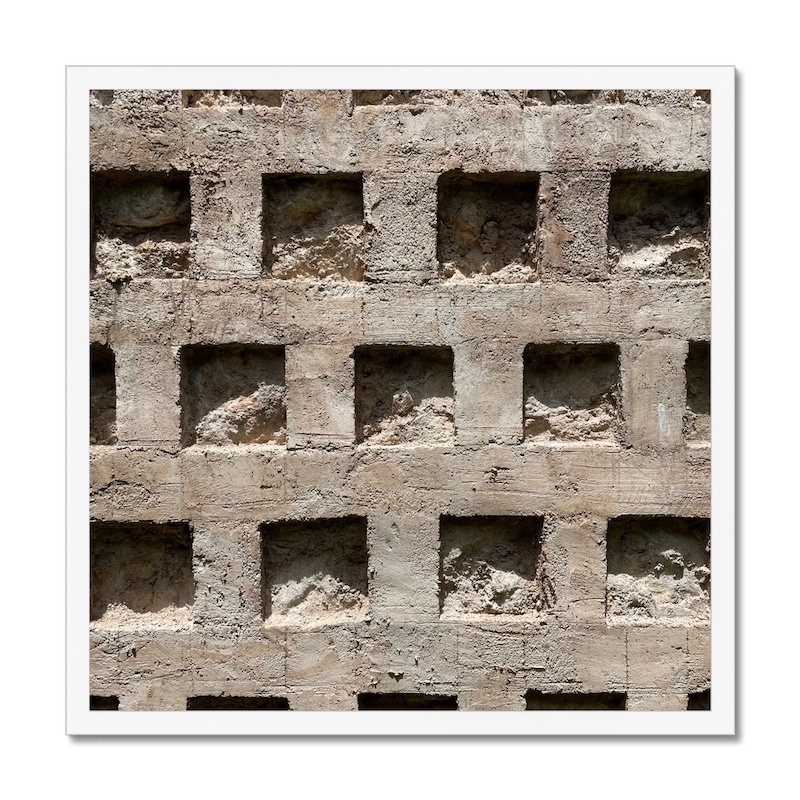 20x20 inch photo in a white frame of a concrete wall with a pattern of square recesses.