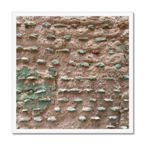 20x20” framed photograph of a crumbled concrete wall with rows of green painted protrusions.