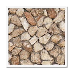 Photograph of roughly hewn stones assembled into a rugged and sturdy wall that is mounted in a white 20x20" frame.