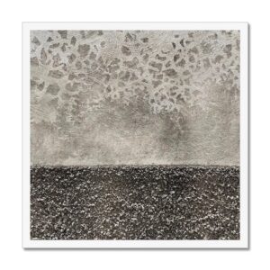 Photo depicting strong textural contrast between smooth blotchy upper and rough gritty lower levels mounted in 20x20" white picture frame.