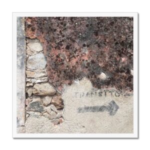 Framed 20x20 photo: an old wall with a stone section and stenciled arrow, in a white frame.