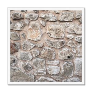 Sturdy rock wall reminiscent of a fortress bulwark or vault photographed and framed as wall hanging.