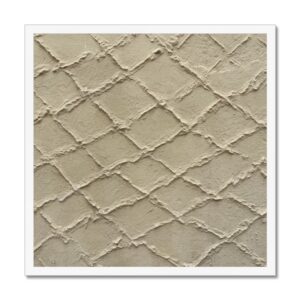 Raised concrete crisscross fishing net pattern on a khaki colored wall in a 20x20 white frame.