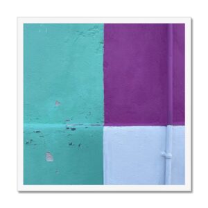 Photo of teal, deep purple, and white solid blocks of color painted on a wall in a white 20x20 frame.